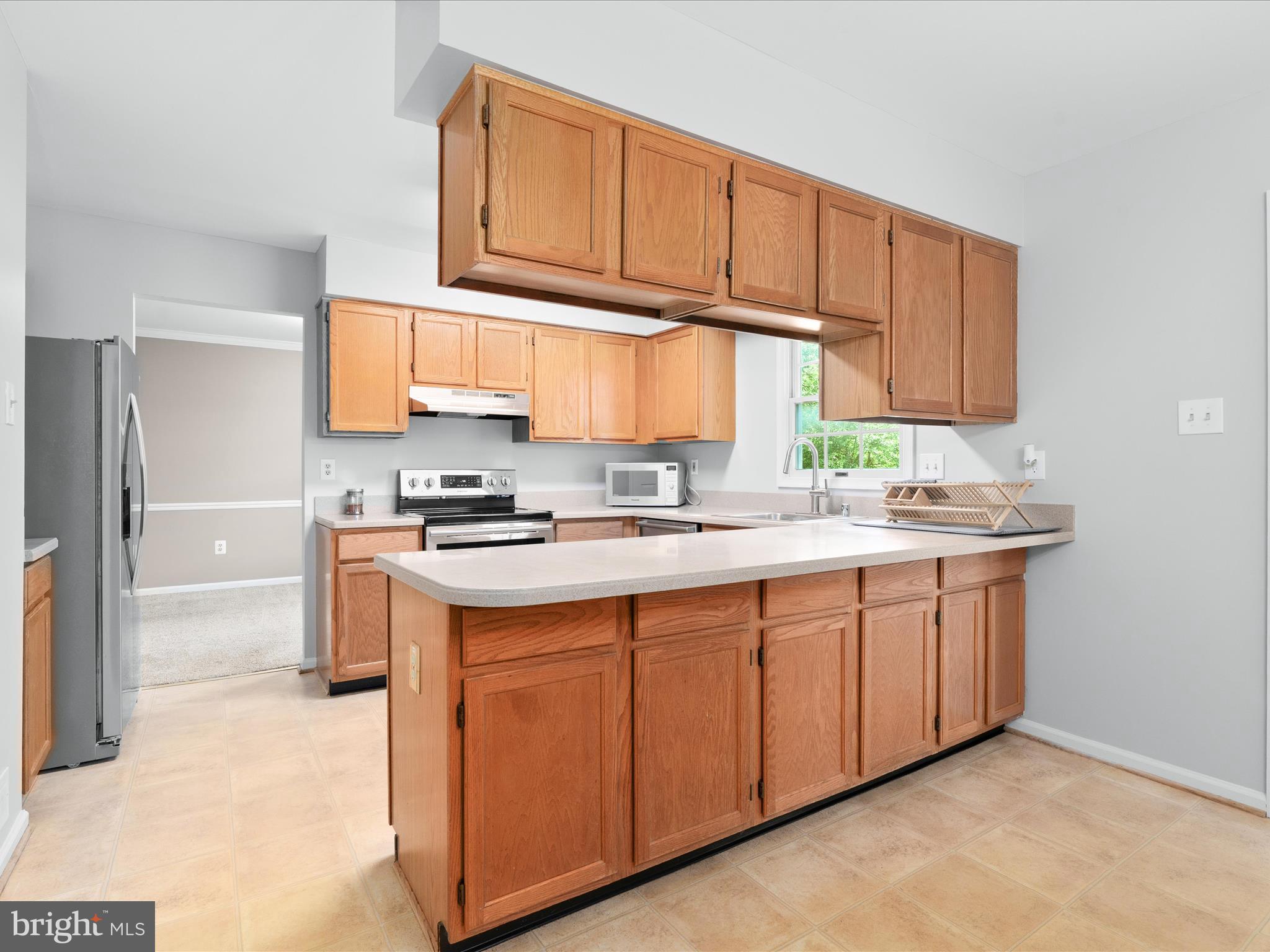 4609 Feldspar Road Middletown, MD 21769 - Photo 20 of 63 a kitchen with stainless steel appliances granite countertop a sink stove and refrigerator