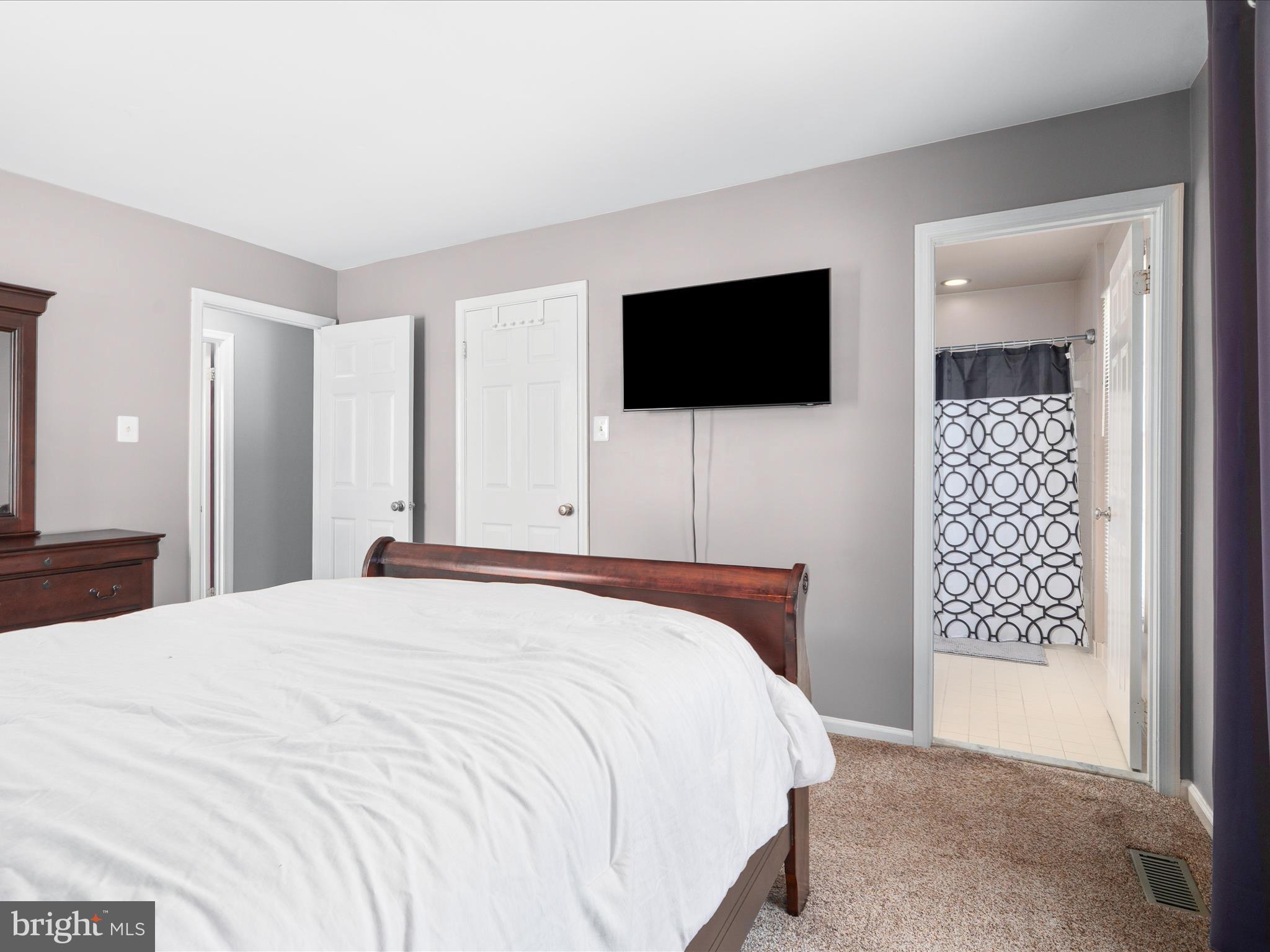 4609 Feldspar Road Middletown, MD 21769 - Photo 36 of 63 a bedroom with a bed and a flat screen tv