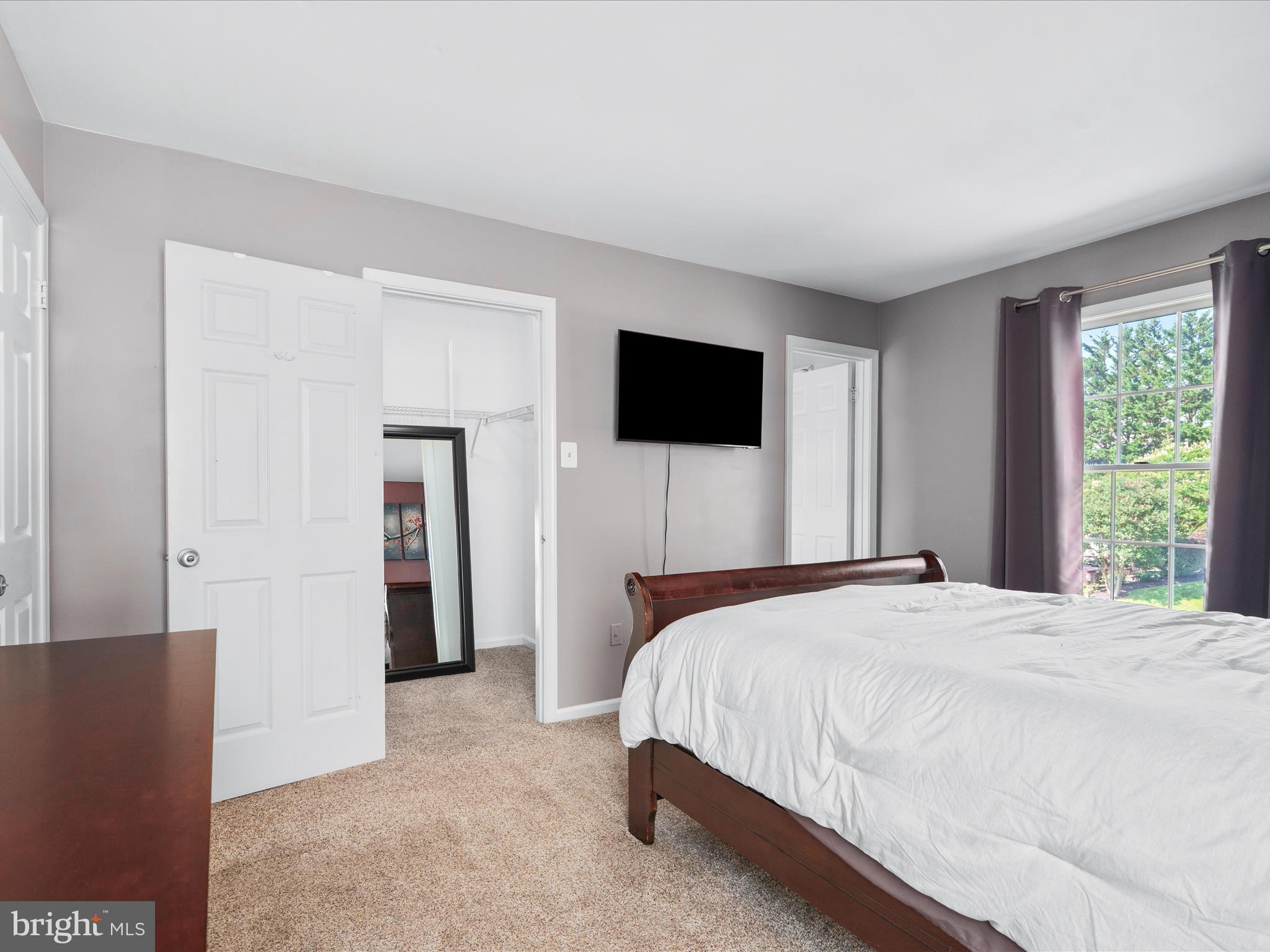 4609 Feldspar Road Middletown, MD 21769 - Photo 37 of 63 a bedroom with a bed and a flat screen tv