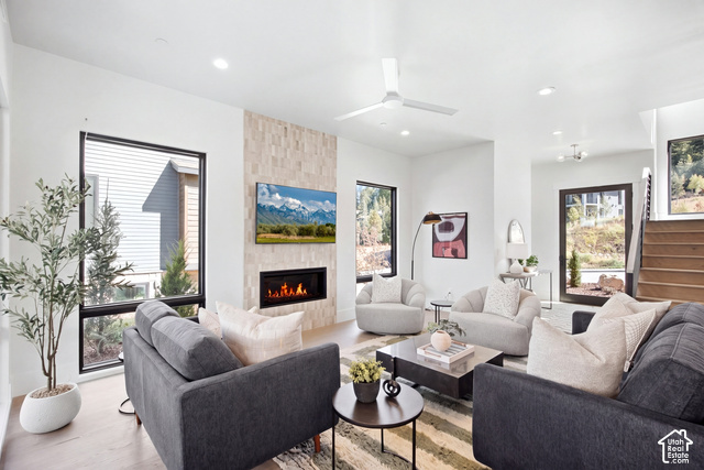 4092 Discovery Way Park City, UT 84098 - Photo 18 of 66 Open-concept living space featuring wood-finish flooring, a contemporary fireplace with a tiled surround, recessed lighting, and a modern ceiling fan