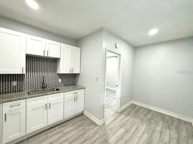 a kitchen with a sink and cabinets