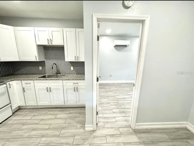 a view of a kitchen with white cabinets