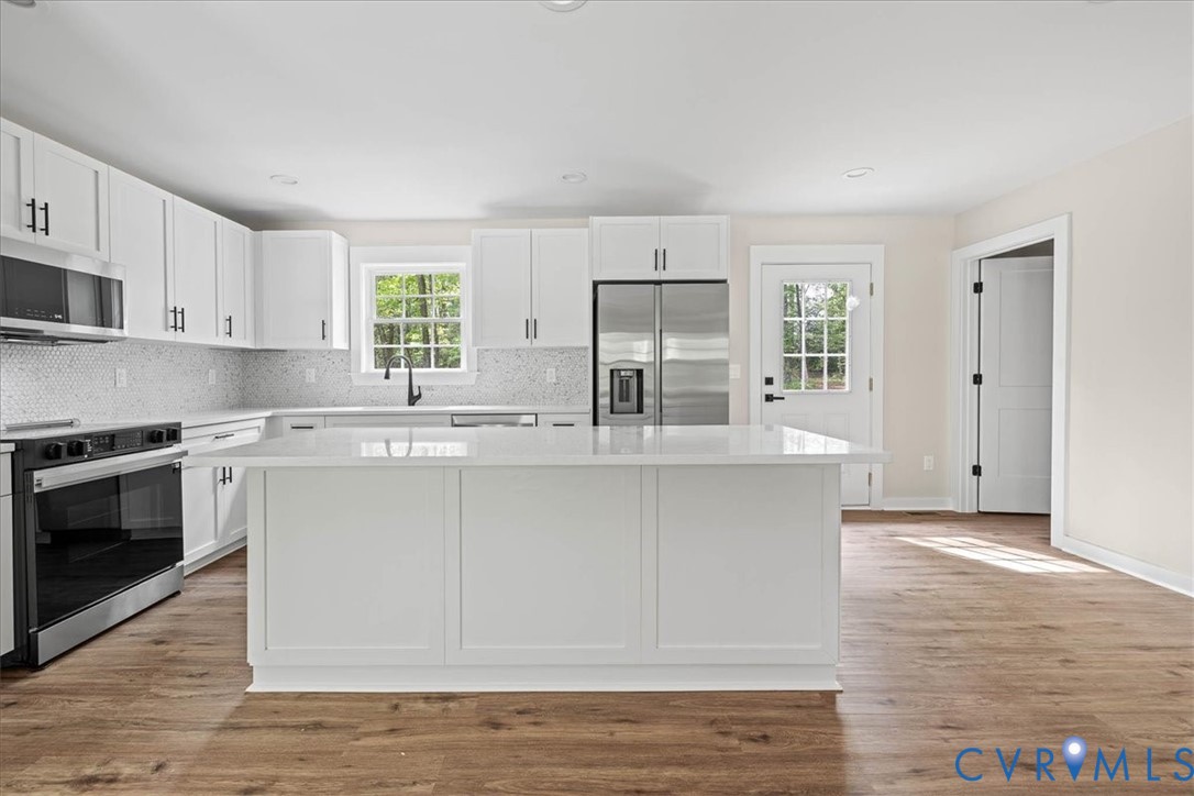 2700 River Road Prince George, VA 23875 - Photo 10 of 24 a kitchen with stainless steel appliances granite countertop a stove a sink and a microwave