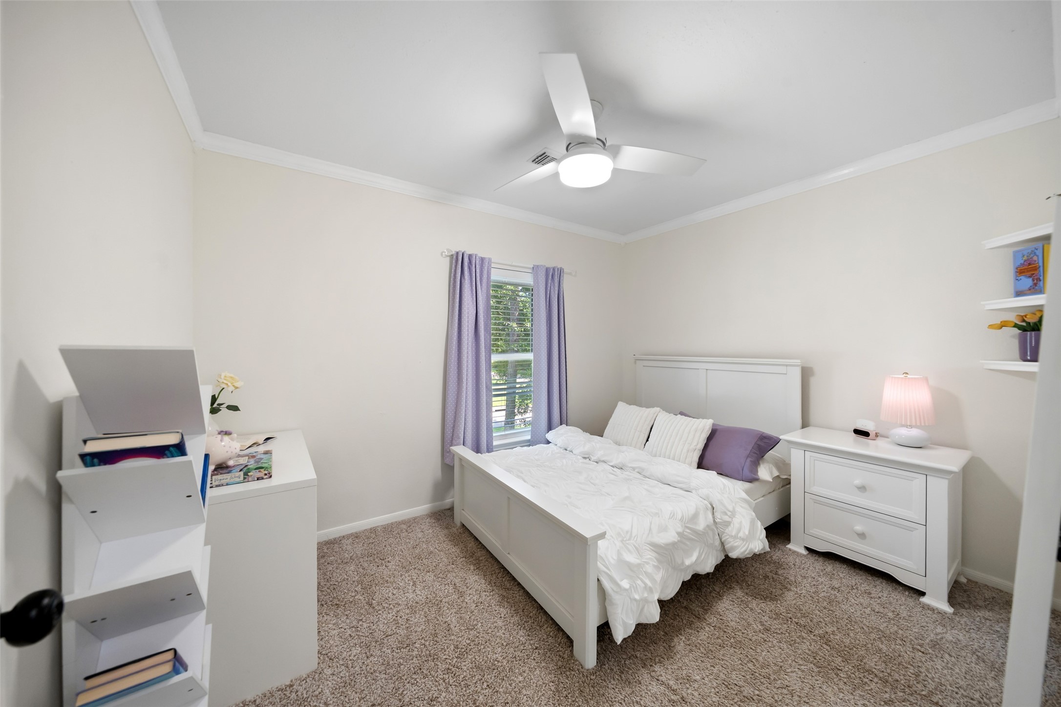 3 East Stony Bridge Circle Spring, TX 77381 - Photo 33 of 42 Another spacious secondary bedroom located on the second floor, featuring a functional layout with a ceiling fan, neutral paint, and carpeting. The built-in closet provides practical storage space.