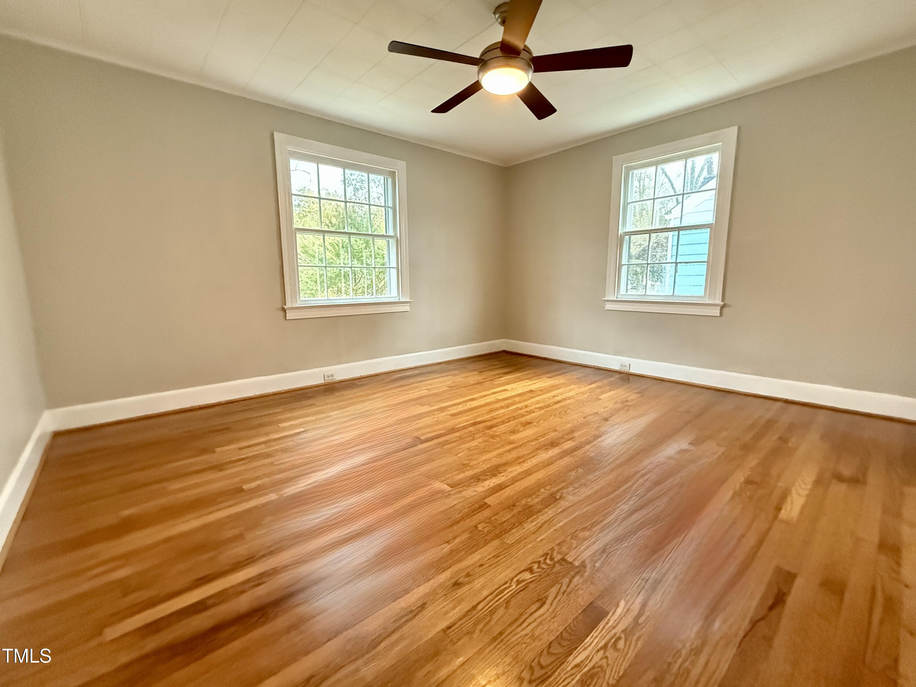 2409 Shenandoah Avenue Durham, NC 27704 - Photo 16 of 31 a view of an empty room with wooden floor and a window