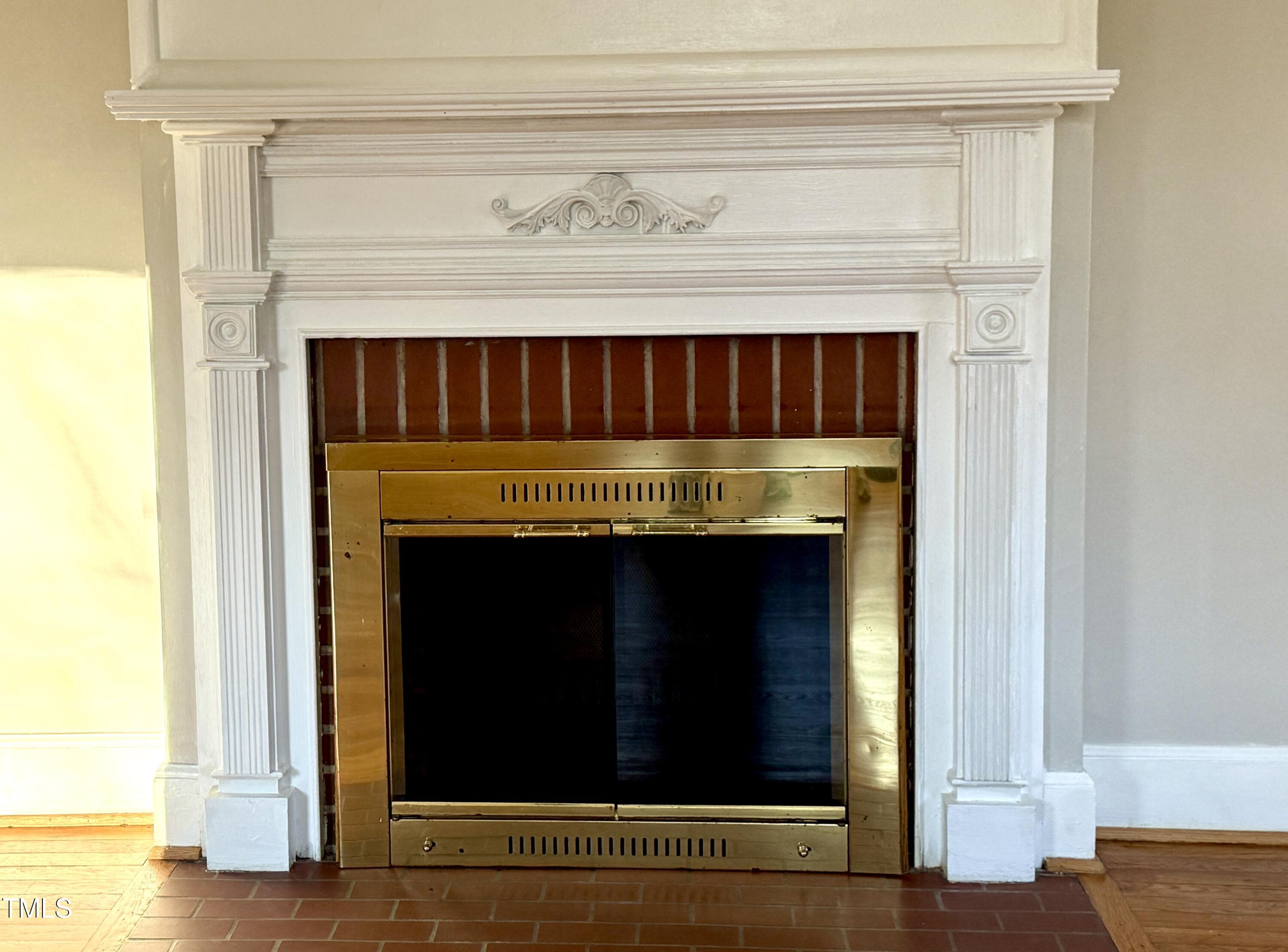 2409 Shenandoah Avenue Durham, NC 27704 - Photo 7 of 31 a close view of a fireplace with a hallway