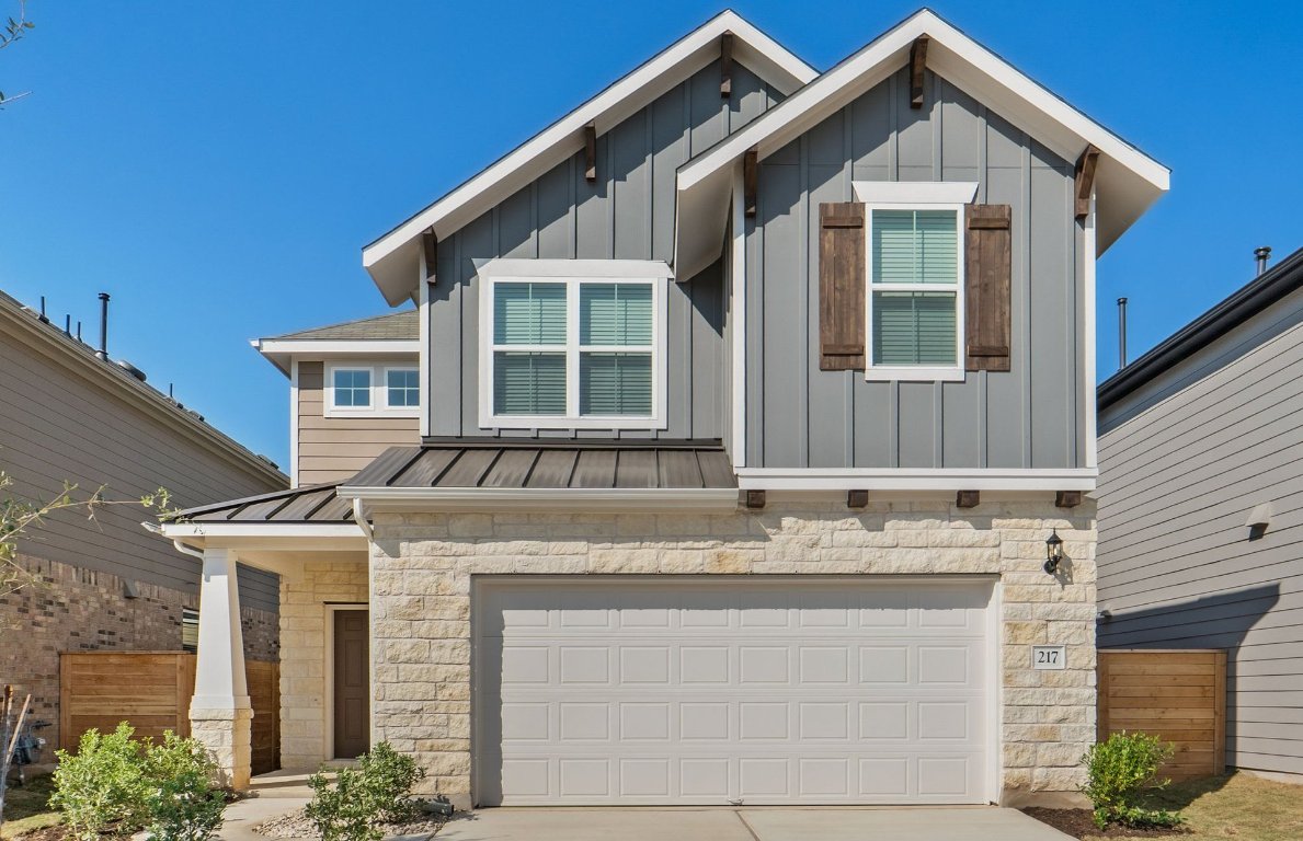 a front view of a house with a garage