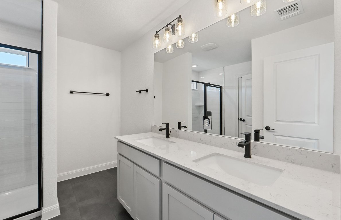 217 Regatta Trail Leander, TX 78641 - Photo 18 of 28 a bathroom with a sink and a mirror