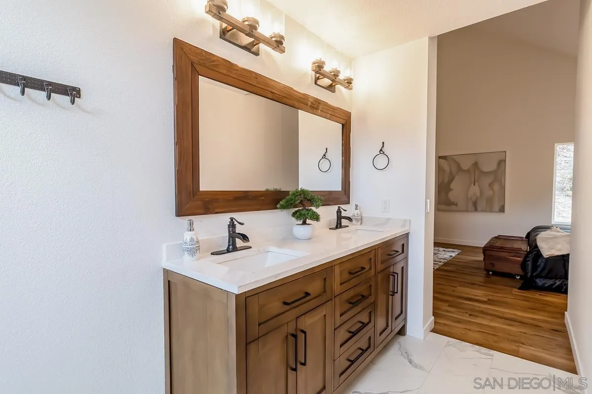 2710 Fernglen Road Carlsbad, CA 92008 - Photo 13 of 37 a bathroom with a sink vanity and mirror