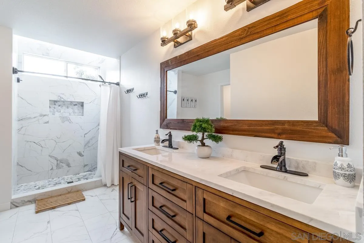 2710 Fernglen Road Carlsbad, CA 92008 - Photo 14 of 37 a bathroom with a sink and a mirror