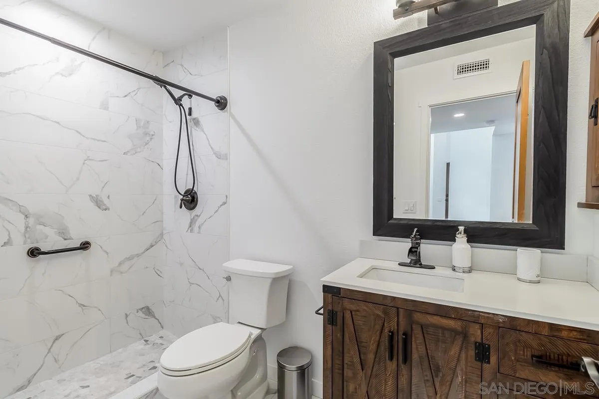 2710 Fernglen Road Carlsbad, CA 92008 - Photo 20 of 37 a bathroom with a sink a toilet and shower