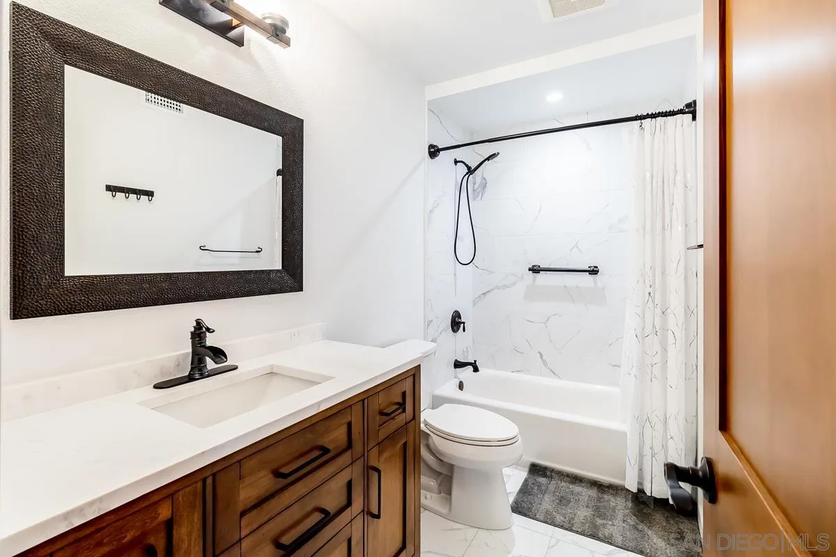 2710 Fernglen Road Carlsbad, CA 92008 - Photo 23 of 37 a bathroom with a bathtub shower sink vanity and toilet