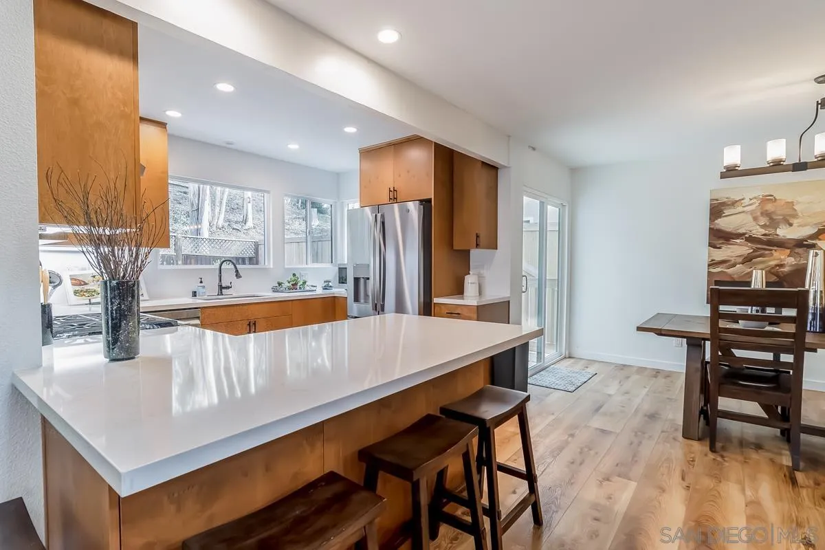2710 Fernglen Road Carlsbad, CA 92008 - Photo 4 of 37 a kitchen with a table chairs sink and cabinets