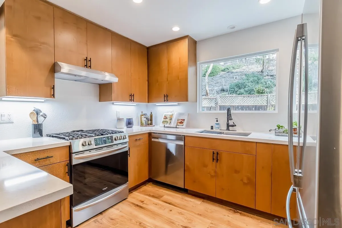 2710 Fernglen Road Carlsbad, CA 92008 - Photo 5 of 37 a kitchen with a stove a sink and a refrigerator