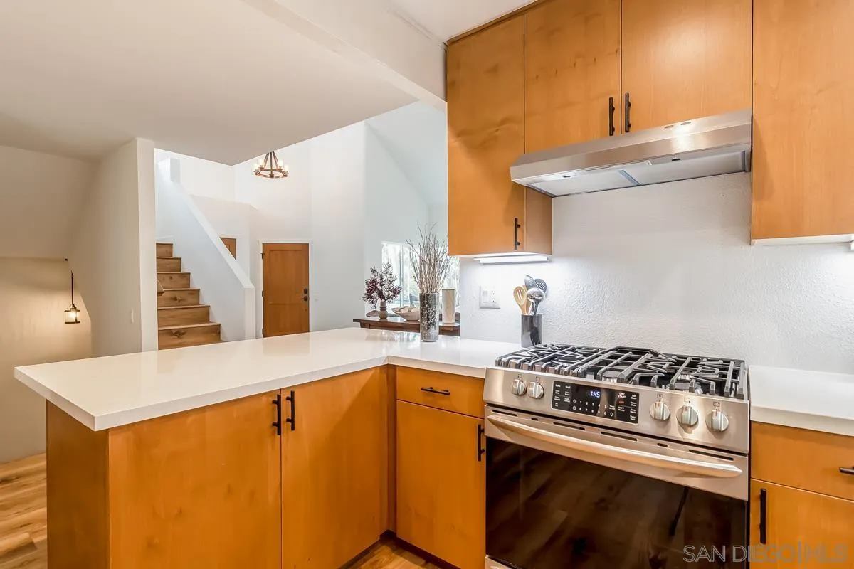 2710 Fernglen Road Carlsbad, CA 92008 - Photo 6 of 37 a kitchen with a stove a sink and a refrigerator