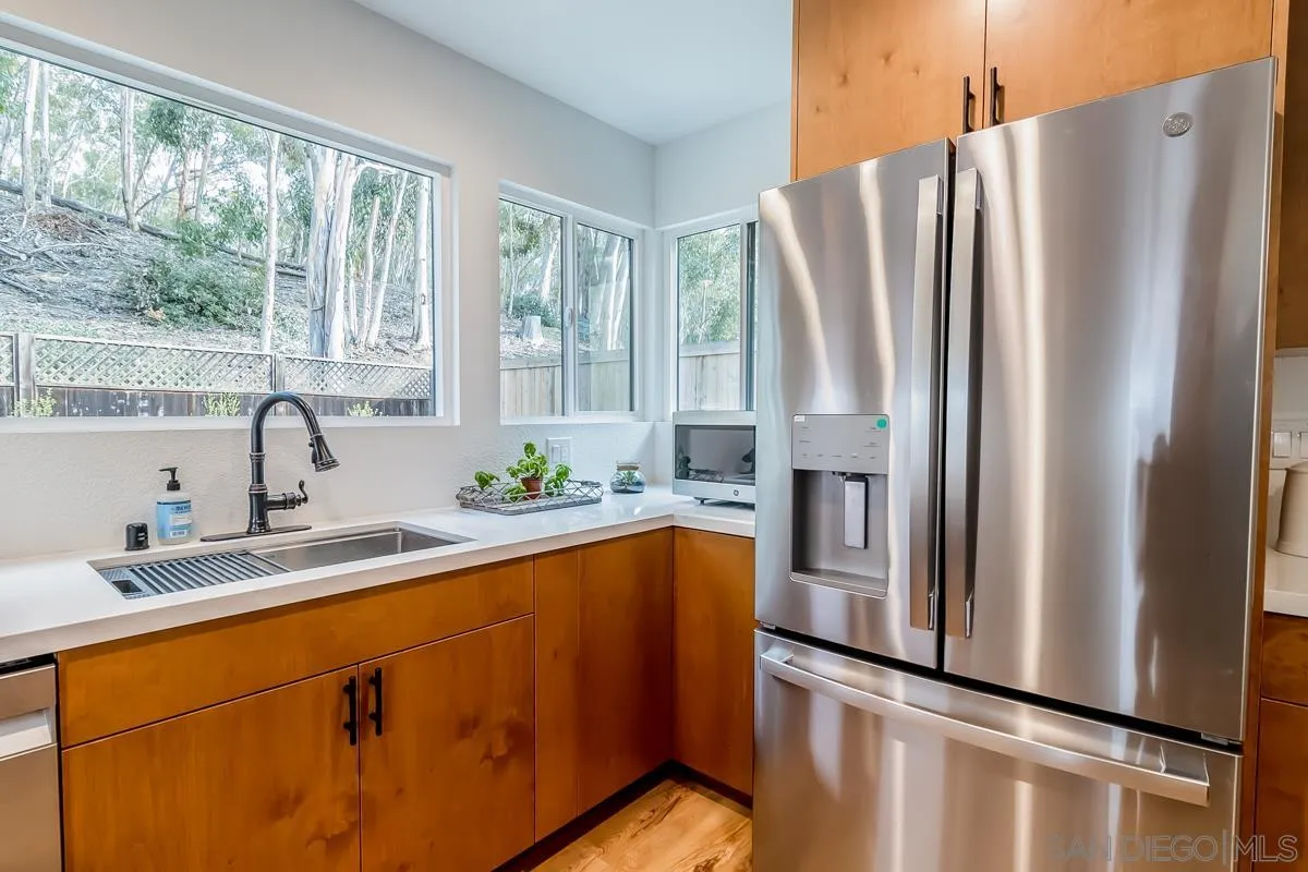 2710 Fernglen Road Carlsbad, CA 92008 - Photo 7 of 37 a kitchen with stainless steel appliances granite countertop a refrigerator and a sink