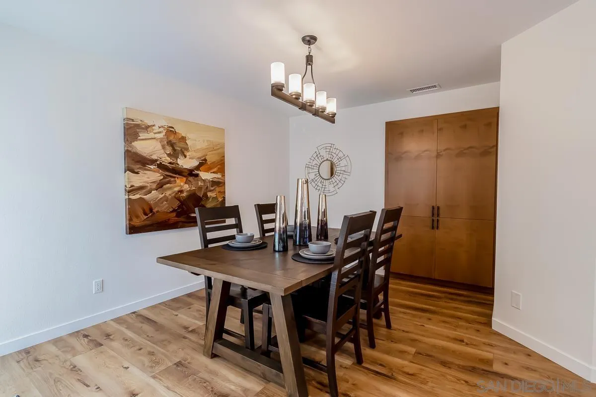 2710 Fernglen Road Carlsbad, CA 92008 - Photo 8 of 37 a view of a dining room with furniture wooden floor and a chandelier