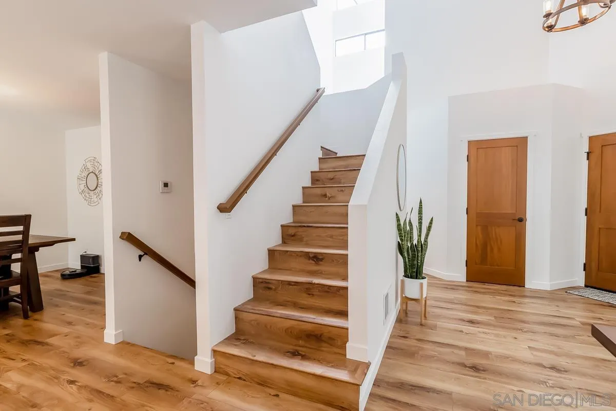 2710 Fernglen Road Carlsbad, CA 92008 - Photo 9 of 37 a view of entryway with wooden floor and stairs