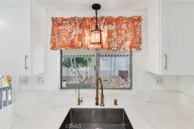 a kitchen with stainless steel appliances a stove microwave and white cabinets