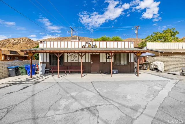 a view of a cafe with a couple of people in a patio