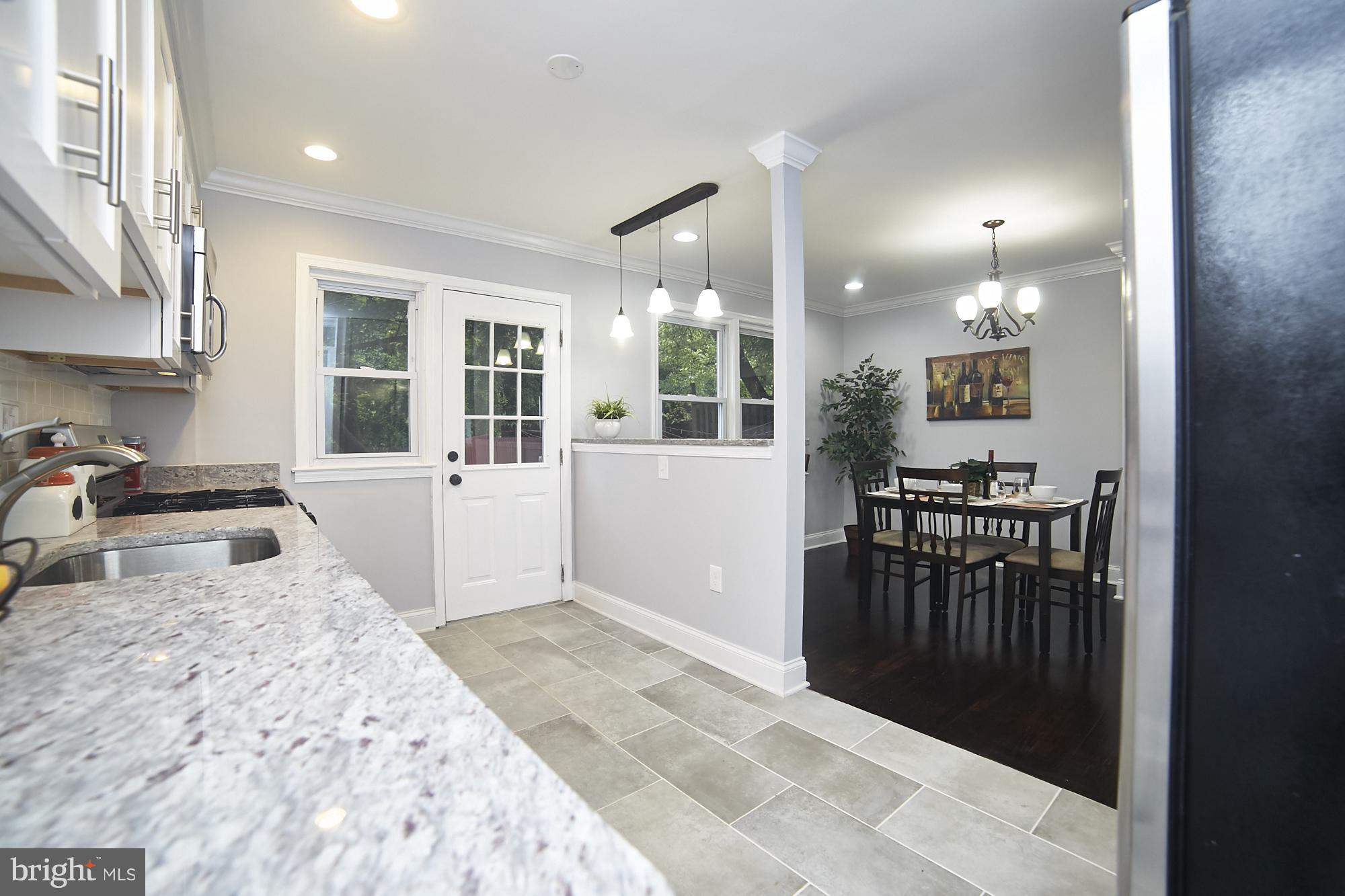 3814 Elkader Road Baltimore, MD 21218 - Photo 11 of 30 a bedroom with a bed and glass door
