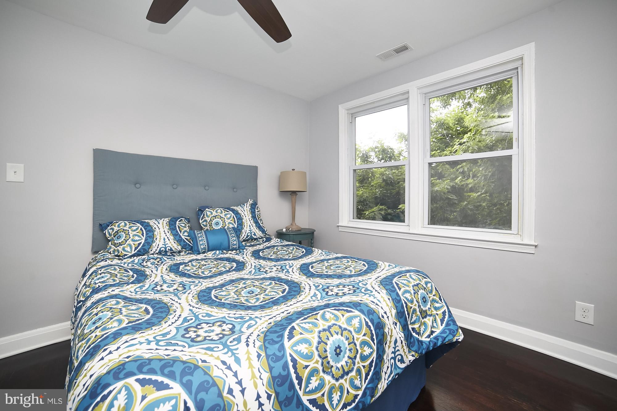 3814 Elkader Road Baltimore, MD 21218 - Photo 13 of 30 a bed sitting in a bedroom next to a window