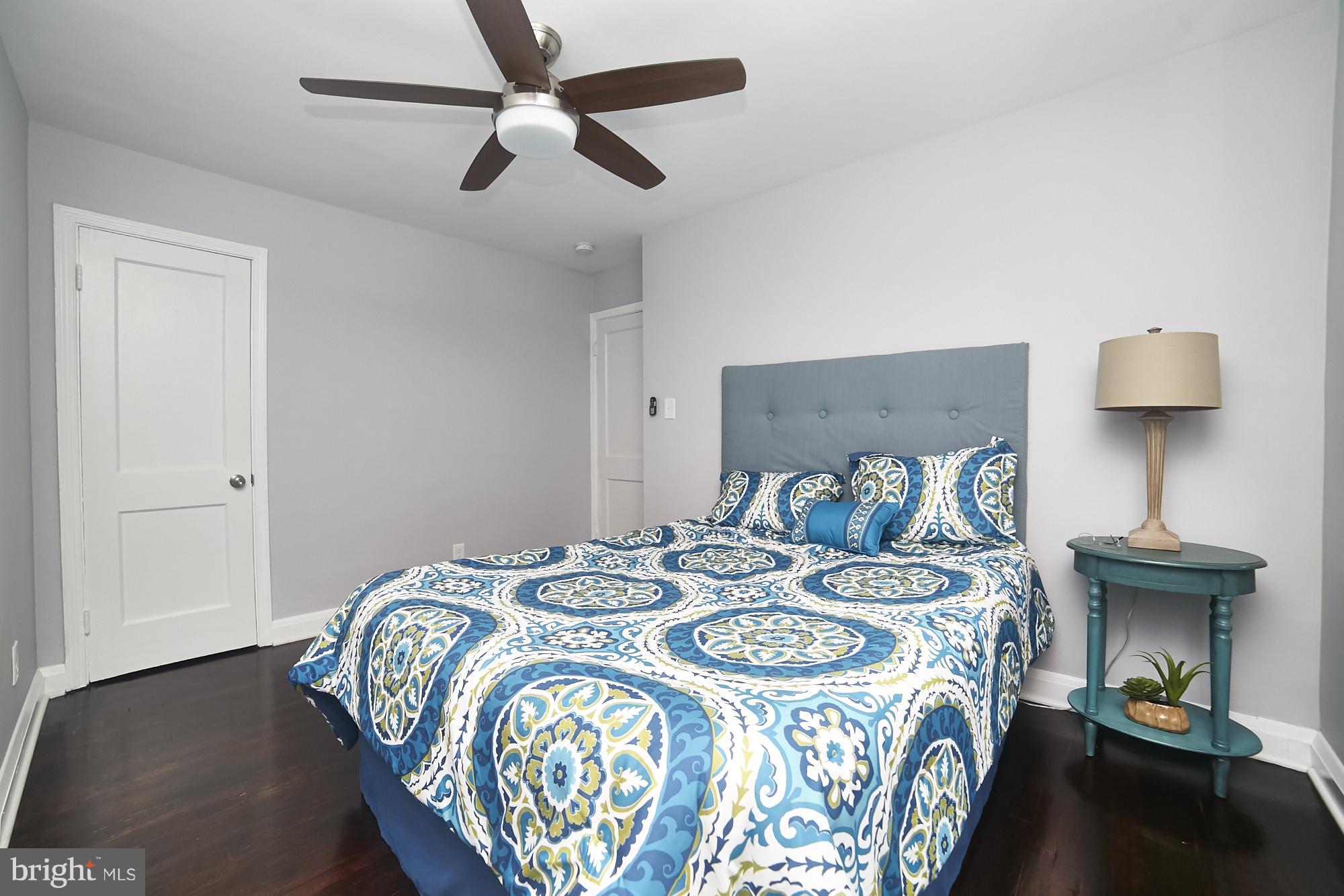 3814 Elkader Road Baltimore, MD 21218 - Photo 14 of 30 a bedroom with a bed and a lamp on dresser