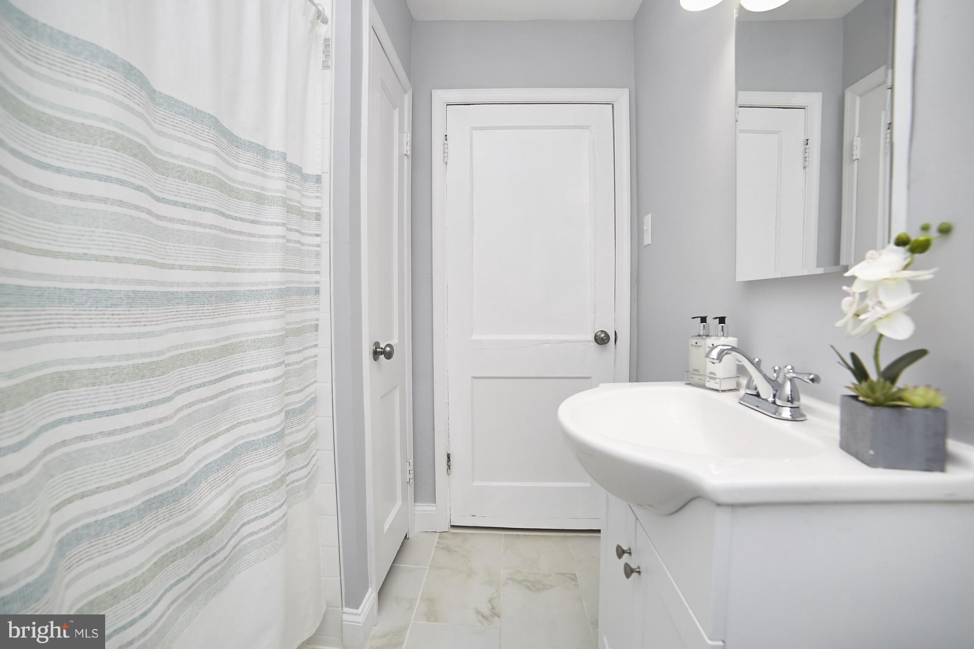 3814 Elkader Road Baltimore, MD 21218 - Photo 18 of 30 a bathroom with a sink and a mirror