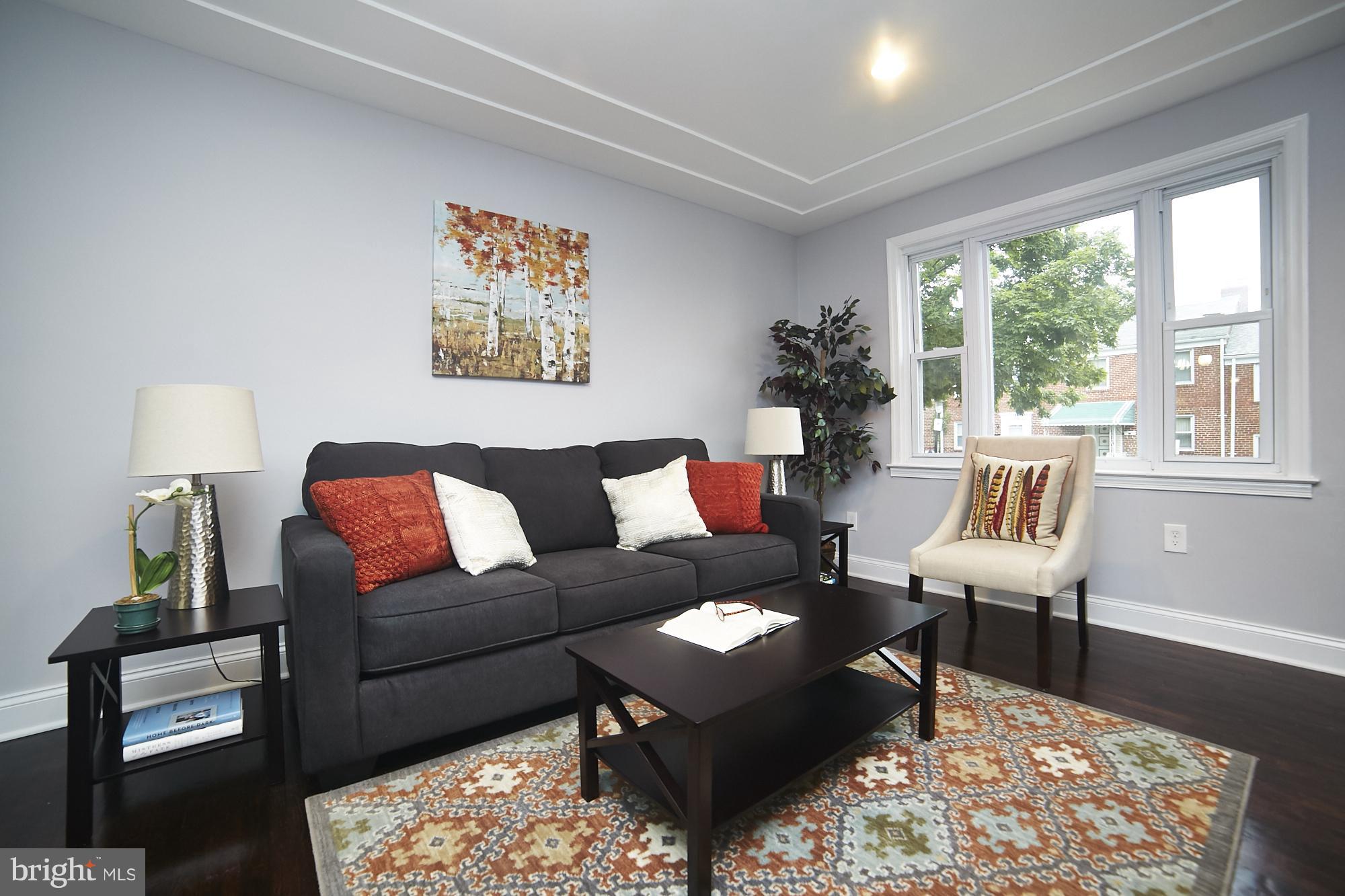 3814 Elkader Road Baltimore, MD 21218 - Photo 3 of 30 a living room with furniture wooden floor and a lamp