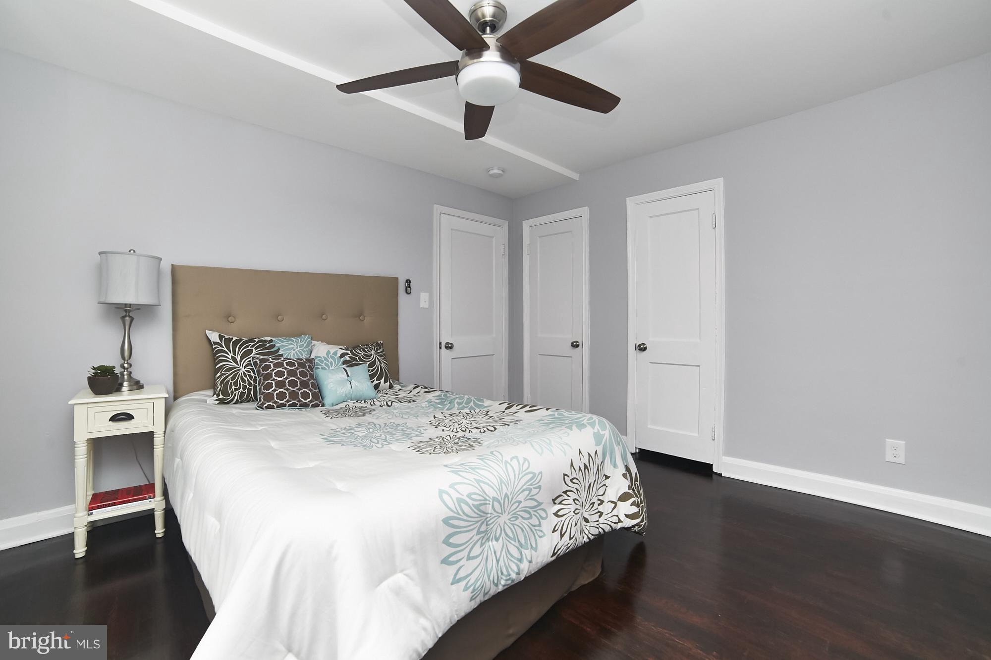 3814 Elkader Road Baltimore, MD 21218 - Photo 21 of 30 a bedroom with a bed and a chandelier