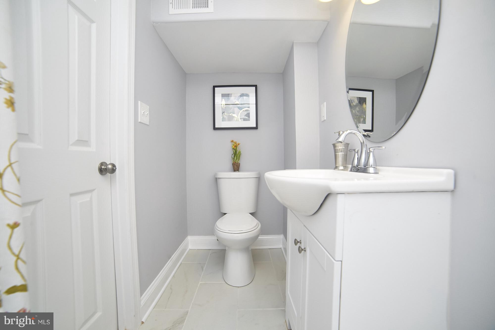 3814 Elkader Road Baltimore, MD 21218 - Photo 29 of 30 a bathroom with a sink toilet and a mirror