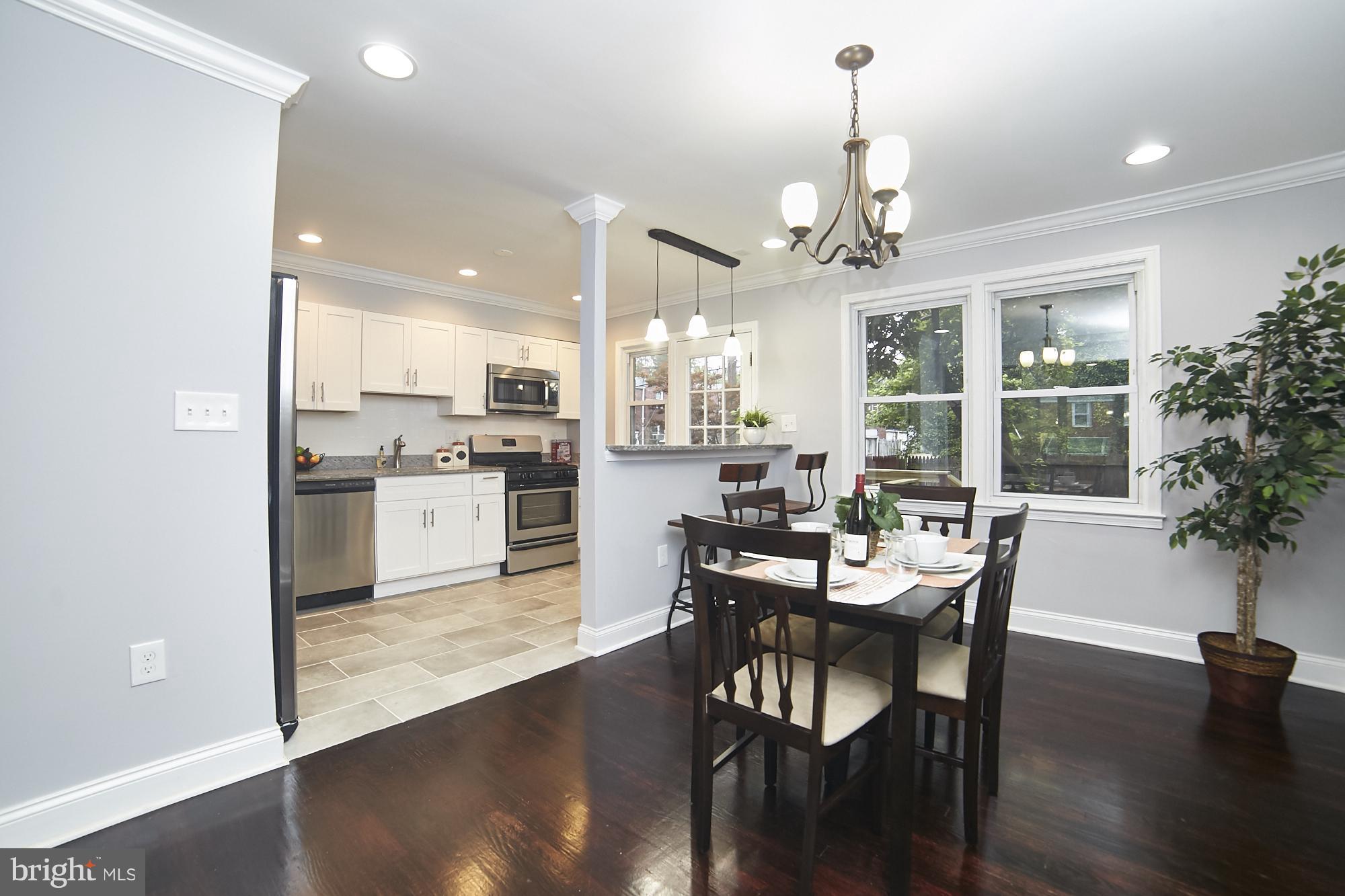 3814 Elkader Road Baltimore, MD 21218 - Photo 5 of 30 a view of a dining room with furniture window and wooden floor