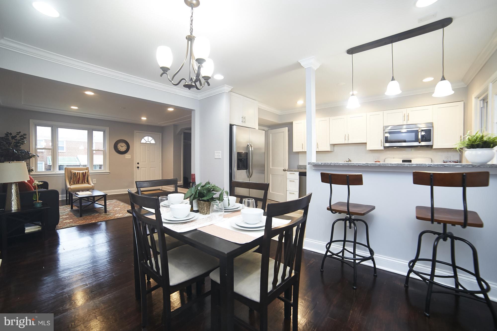 3814 Elkader Road Baltimore, MD 21218 - Photo 6 of 30 a view of a dining room with furniture and wooden floor
