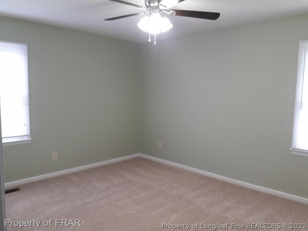 821 Bedford Road Fayetteville, NC 28303 - Photo 11 of 14 an empty room with a window and a fan