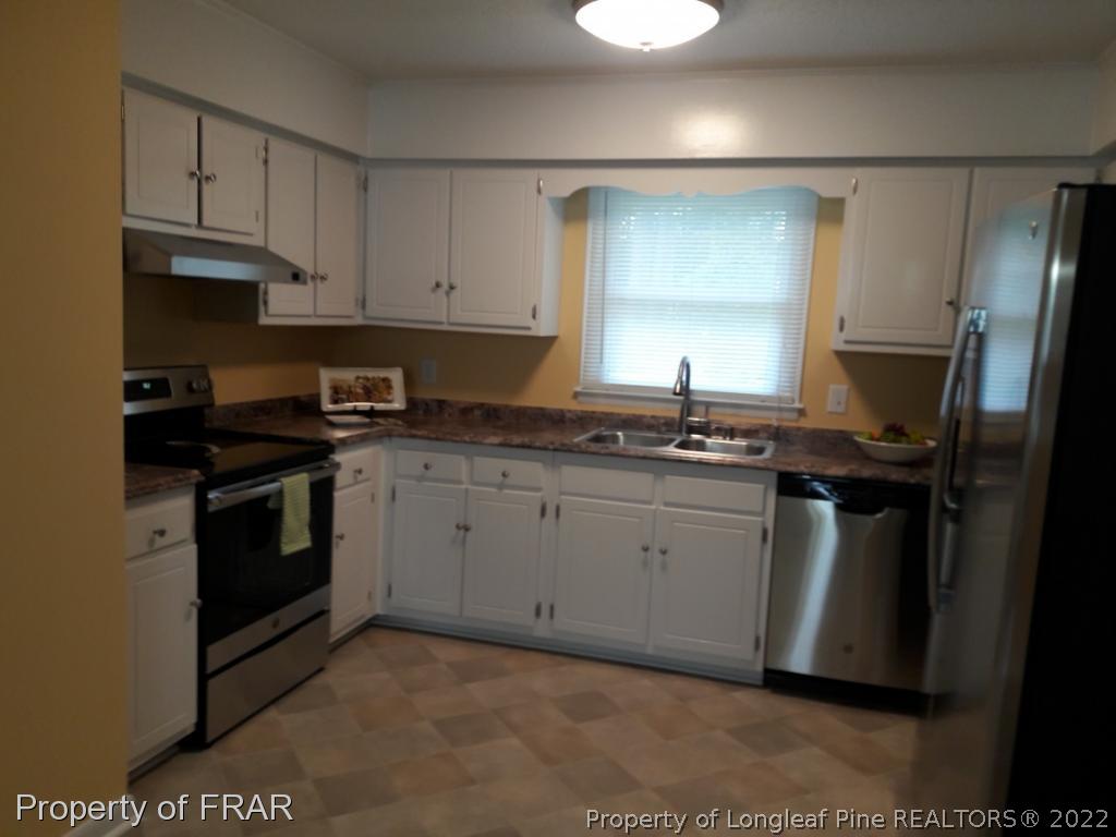 821 Bedford Road Fayetteville, NC 28303 - Photo 2 of 14 a kitchen with a sink stove and refrigerator