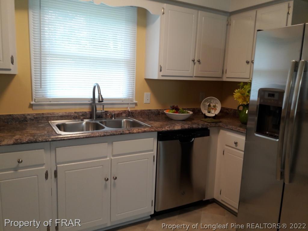 821 Bedford Road Fayetteville, NC 28303 - Photo 4 of 14 a kitchen with stainless steel appliances granite countertop a sink stove and refrigerator