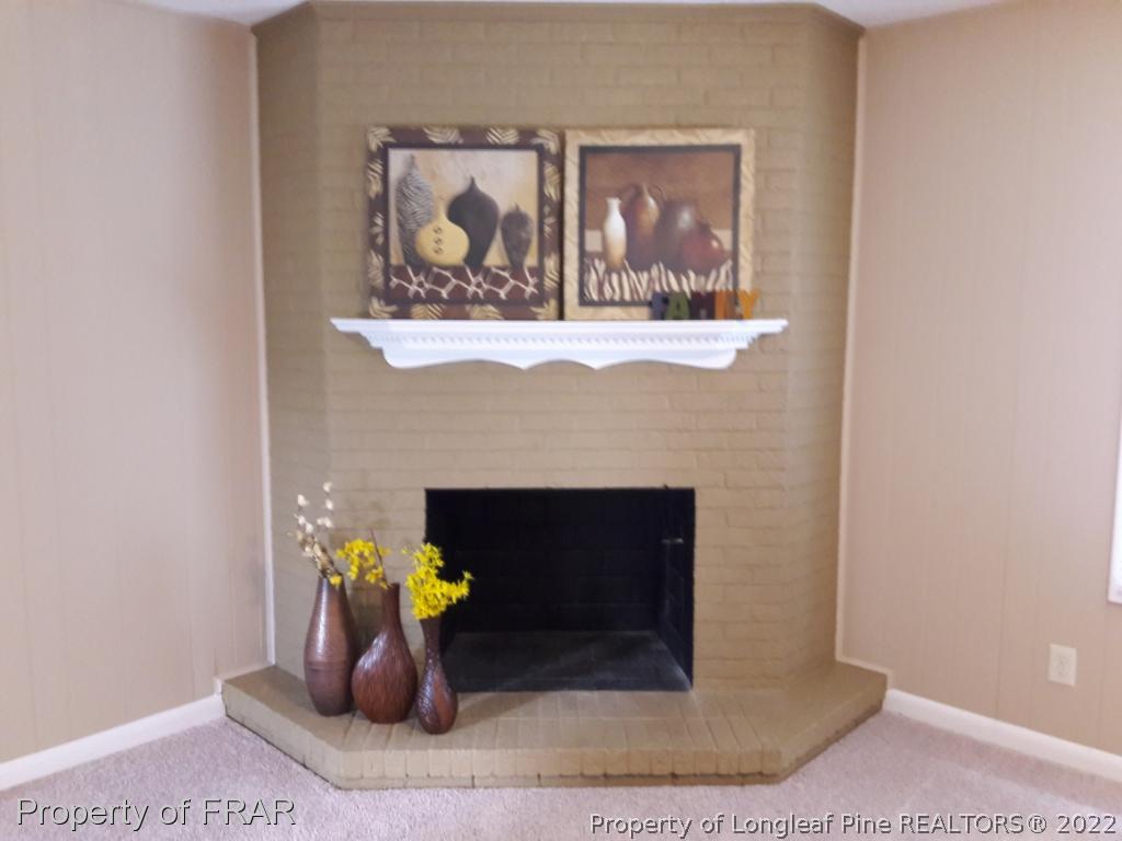 821 Bedford Road Fayetteville, NC 28303 - Photo 8 of 14 a room with fireplace and chair