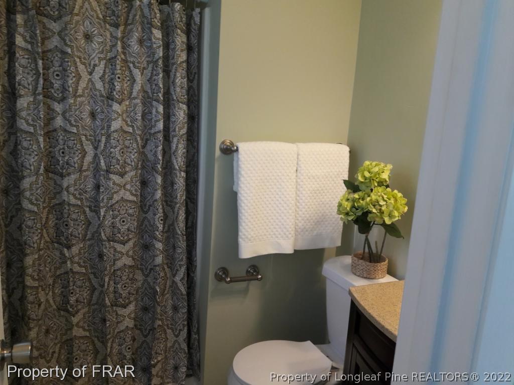 821 Bedford Road Fayetteville, NC 28303 - Photo 10 of 14 a bathroom with a toilet sink and mirror