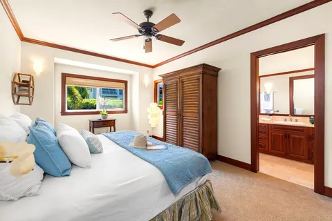 a bedroom with a large bed and a chandelier