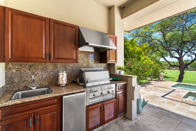 a kitchen with a stove and a white cabinets