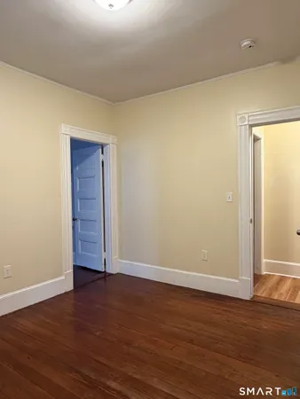 an empty room with wooden floor and closet