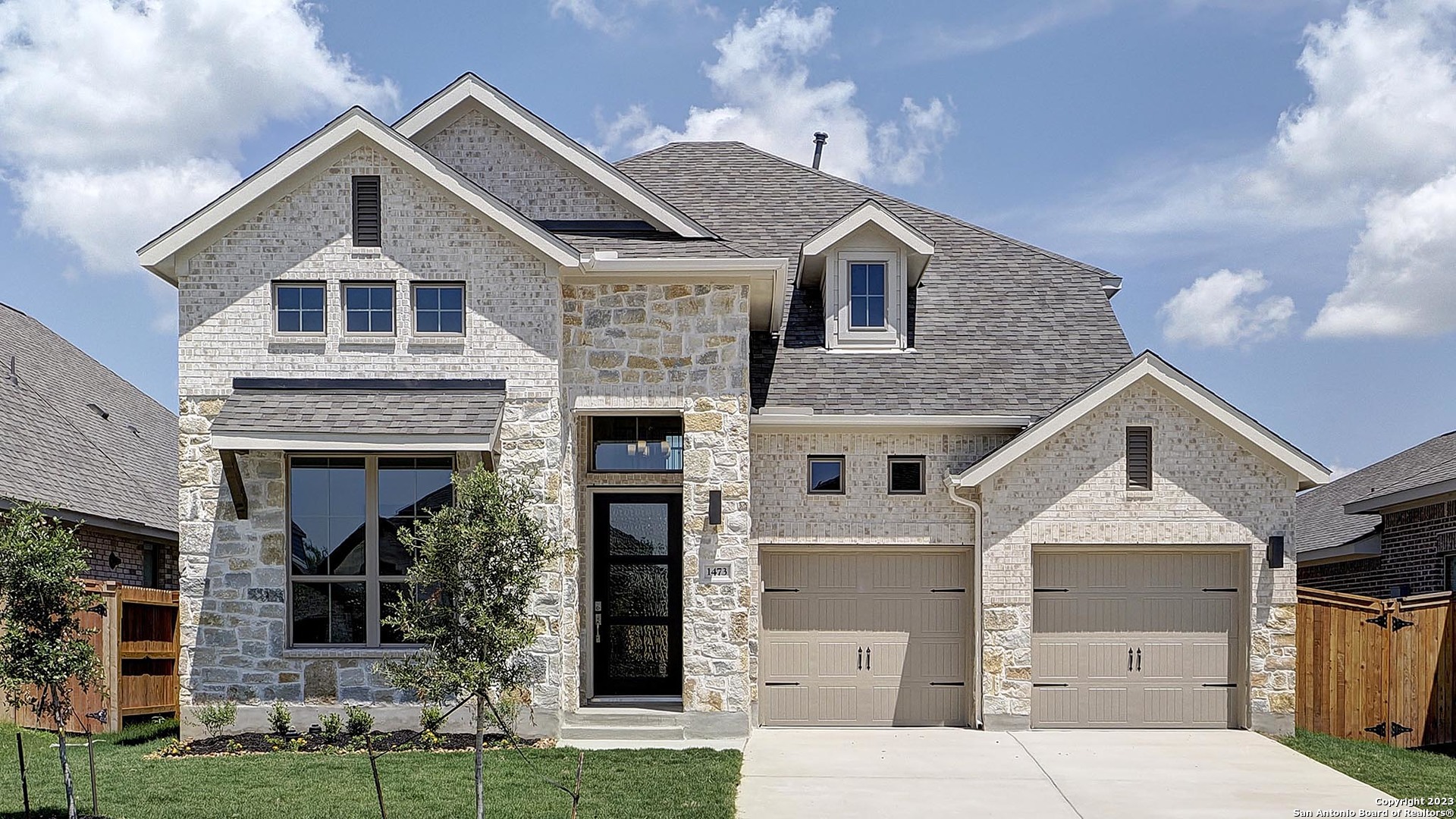 a front view of a house with a yard