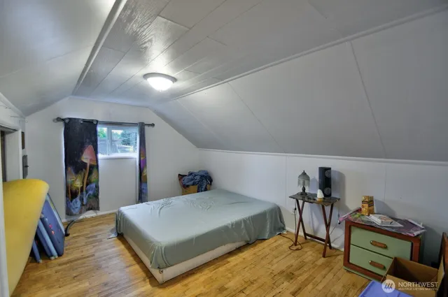 a bed room with furniture and a wooden floor