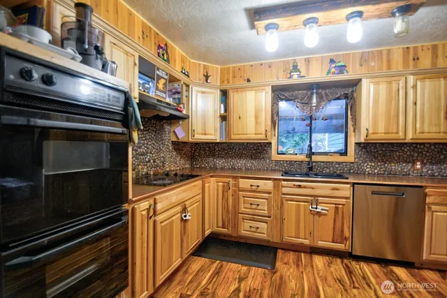 a kitchen with stainless steel appliances a stove sink and cabinets