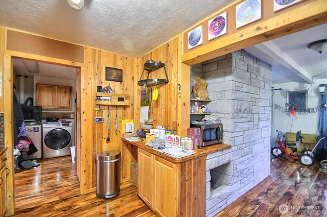 a storage utility room with a sink and cabinets