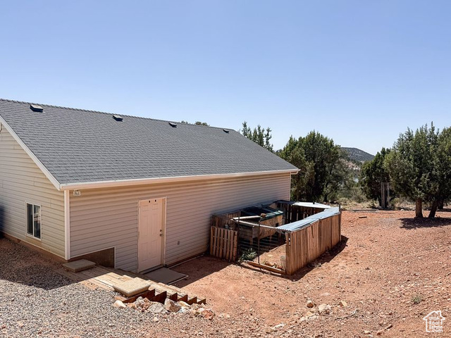425 East Mule Deer Road Central, UT 84722 - Photo 64 of 72 Rear view of property featuring a shingled roof and a mountain view