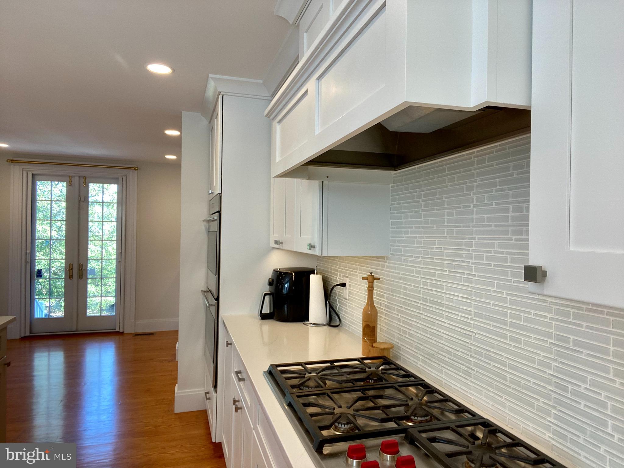 121 Upnor Road Baltimore, MD 21212 - Photo 34 of 79 a kitchen with wooden cabinets and a stove top oven