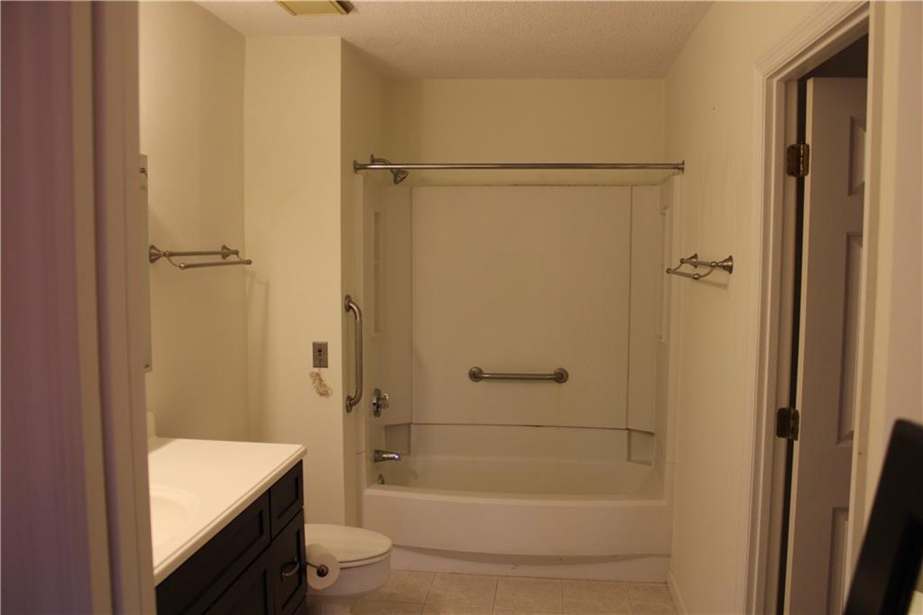 300 Johnson Ferry Road, Unit B802 Atlanta, GA 30328 - Photo 13 of 23 a bathroom with a shower a bathtub and toilet