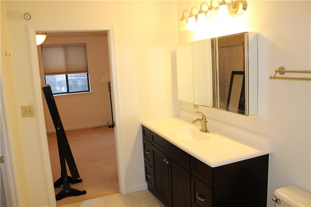 300 Johnson Ferry Road, Unit B802 Atlanta, GA 30328 - Photo 14 of 23 a bathroom with a sink vanity and a mirror