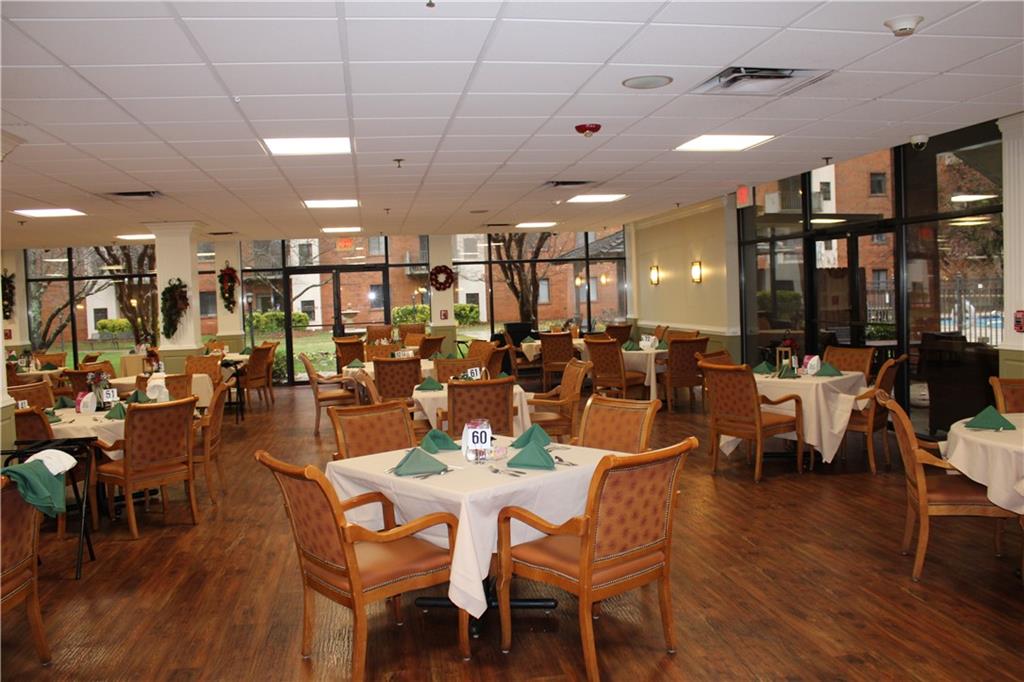 300 Johnson Ferry Road, Unit B802 Atlanta, GA 30328 - Photo 19 of 23 a view of a dining area with furniture and wooden floor